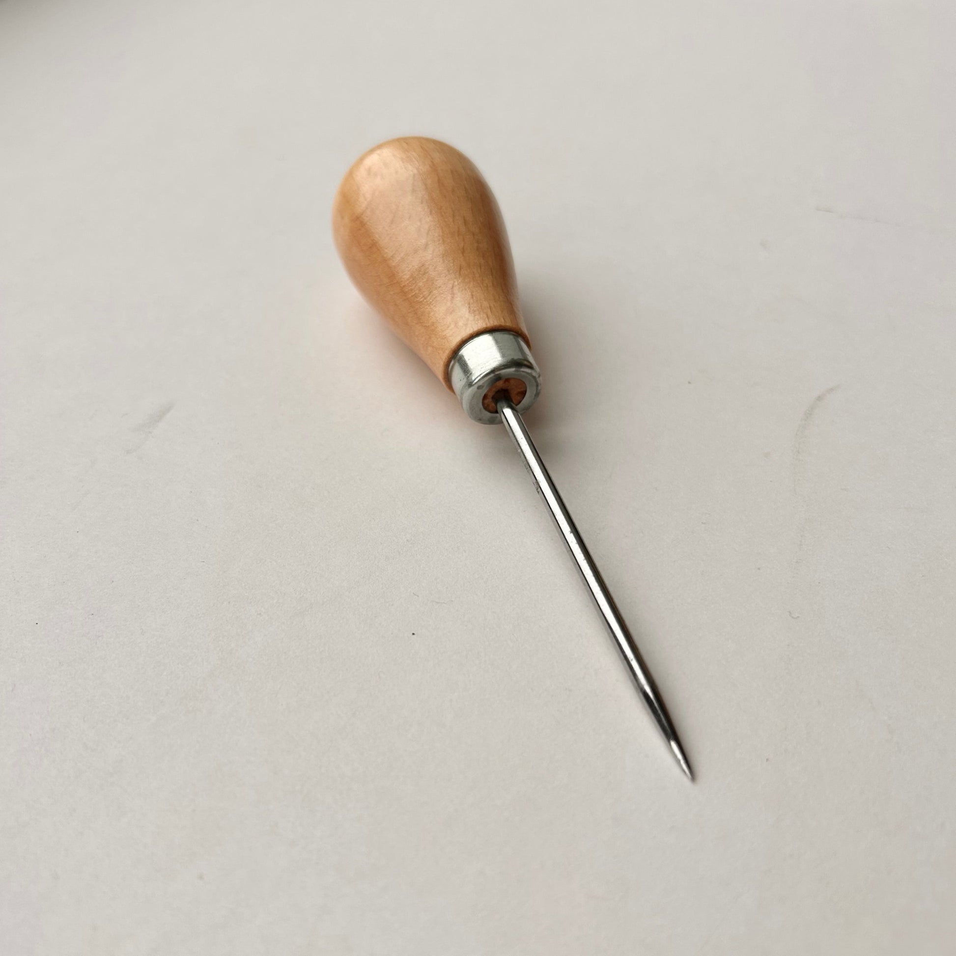 Wooden-handled awl on a white background