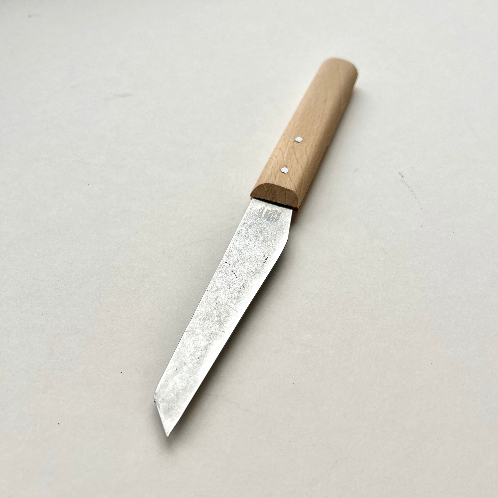 Knife with a wooden handle on a light gray background