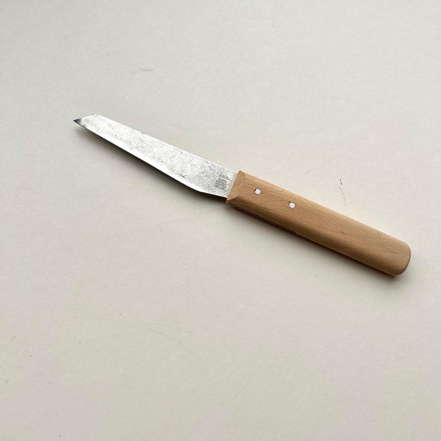 Knife with a wooden handle on a light gray background