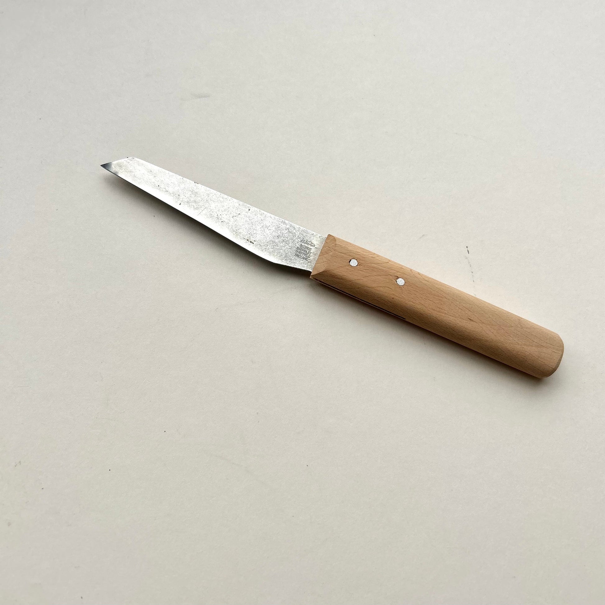Knife with a wooden handle on a light gray background