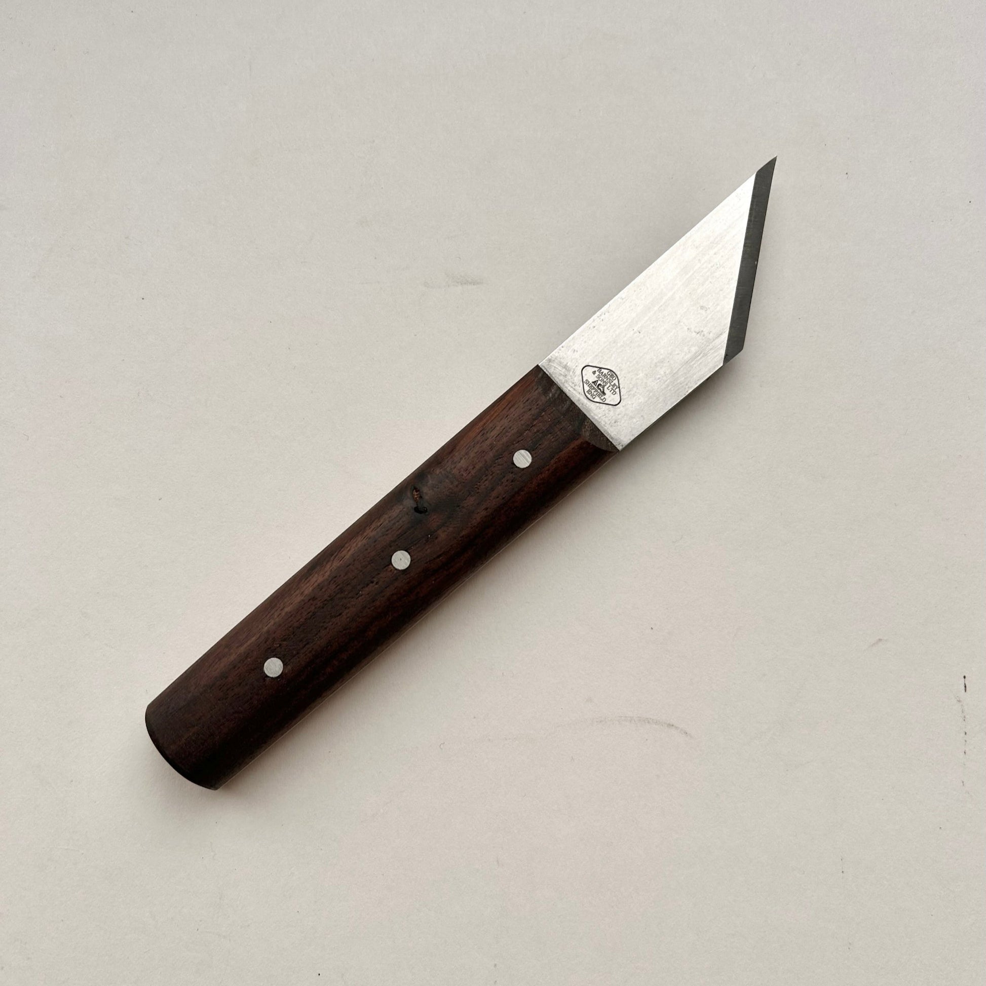 Knife with a wooden handle on a light gray background