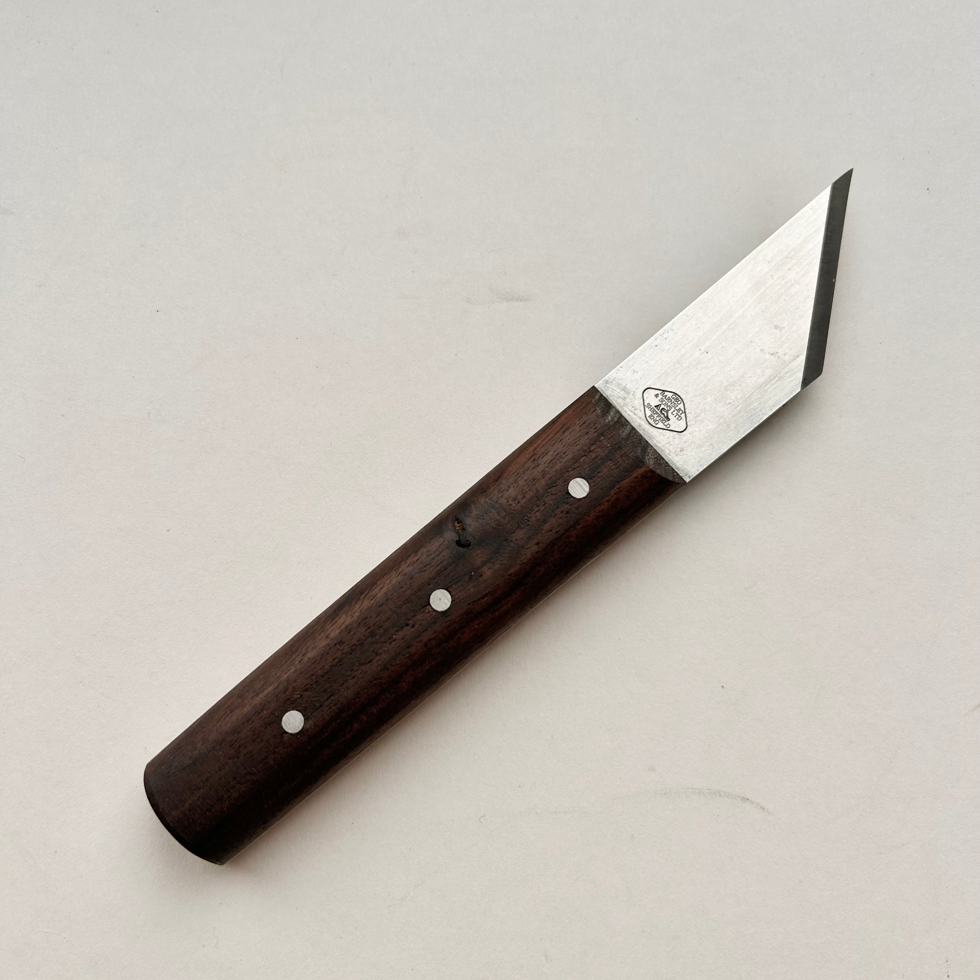 Knife with a wooden handle on a light gray background