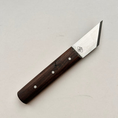 Knife with a wooden handle on a light gray background