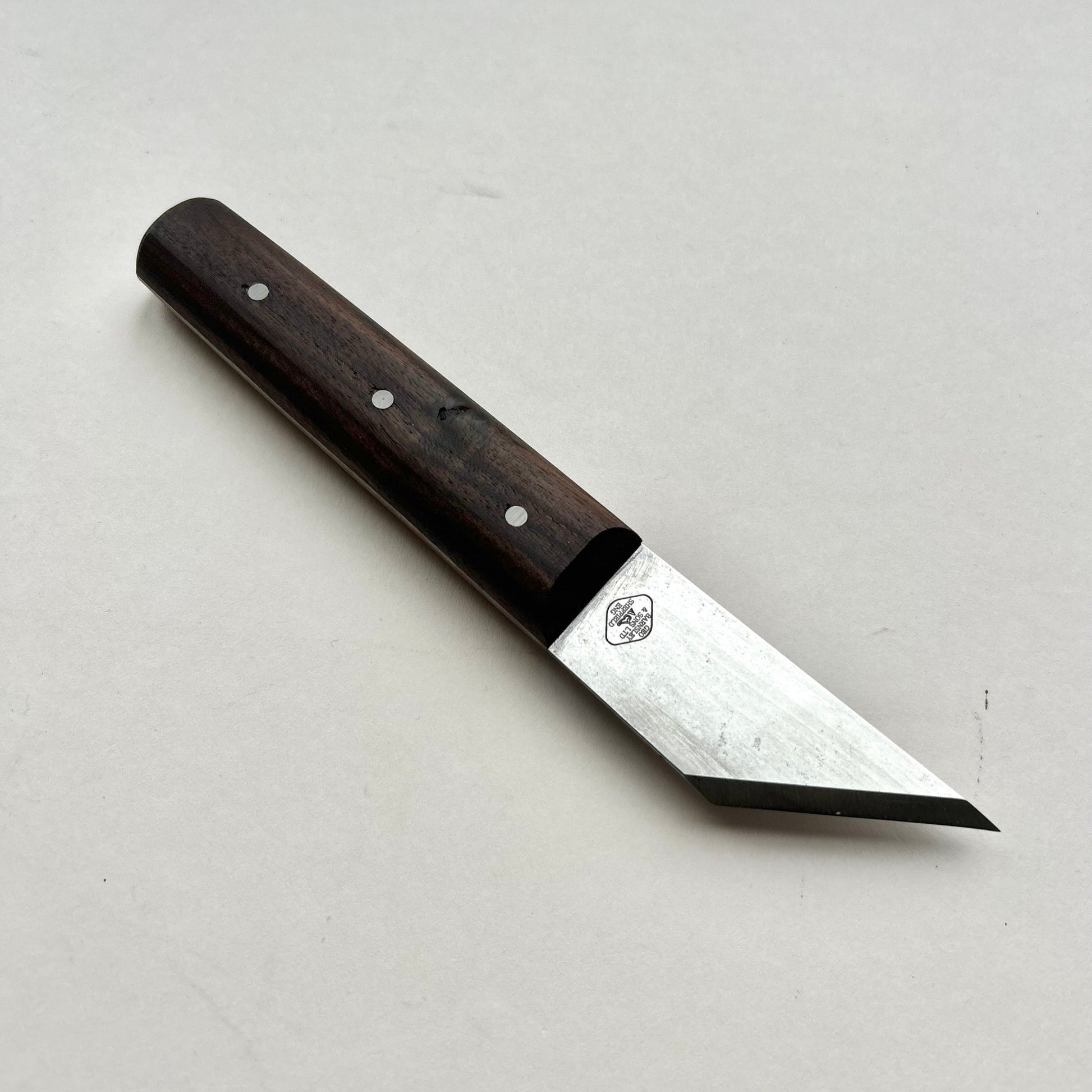 Knife with a wooden handle on a light gray background