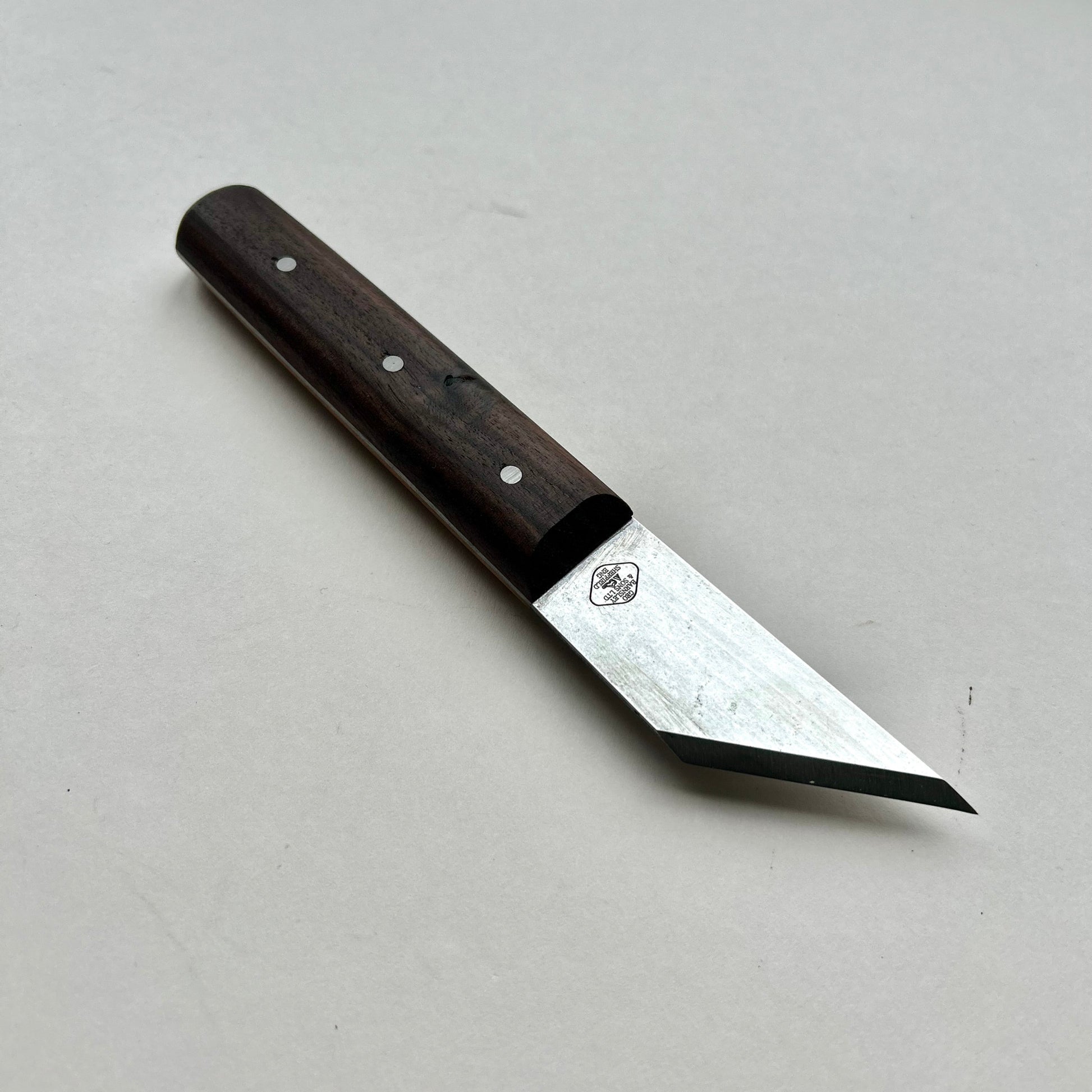 Knife with a wooden handle on a gray surface