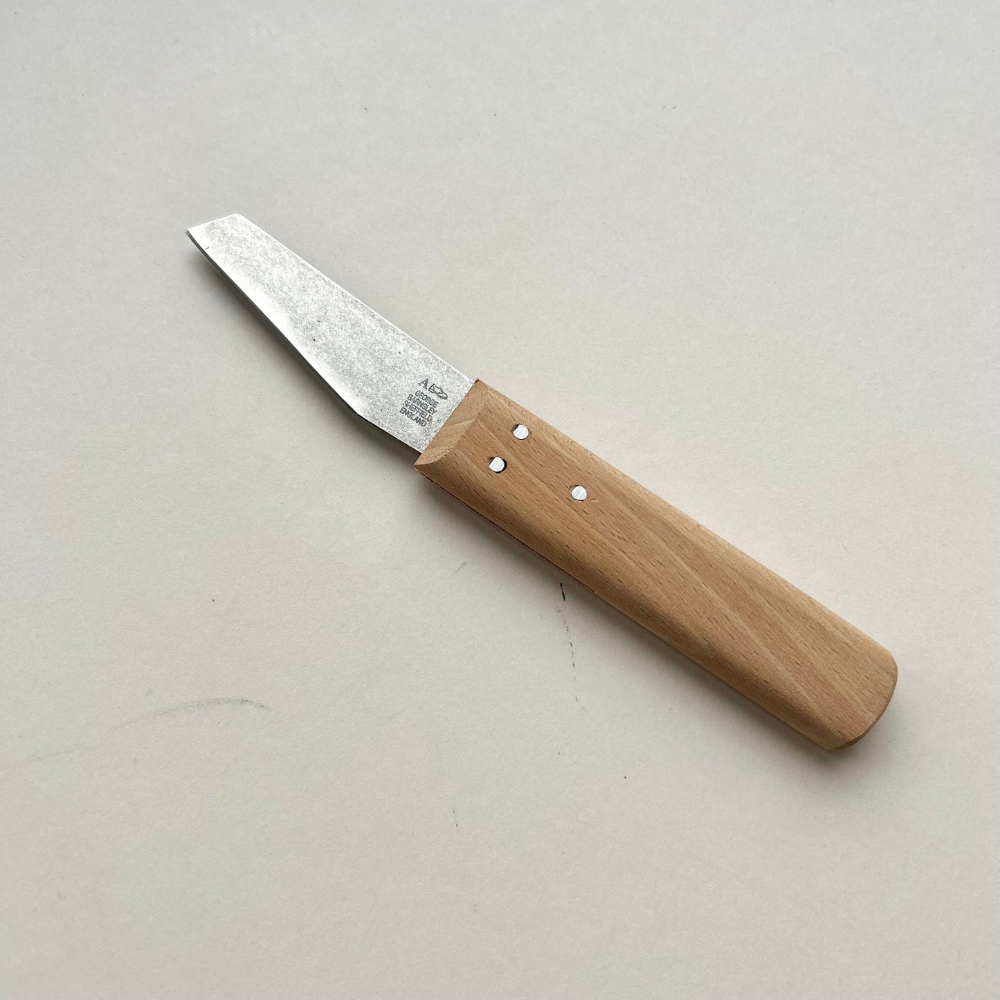 Knife with a wooden handle on a light gray background