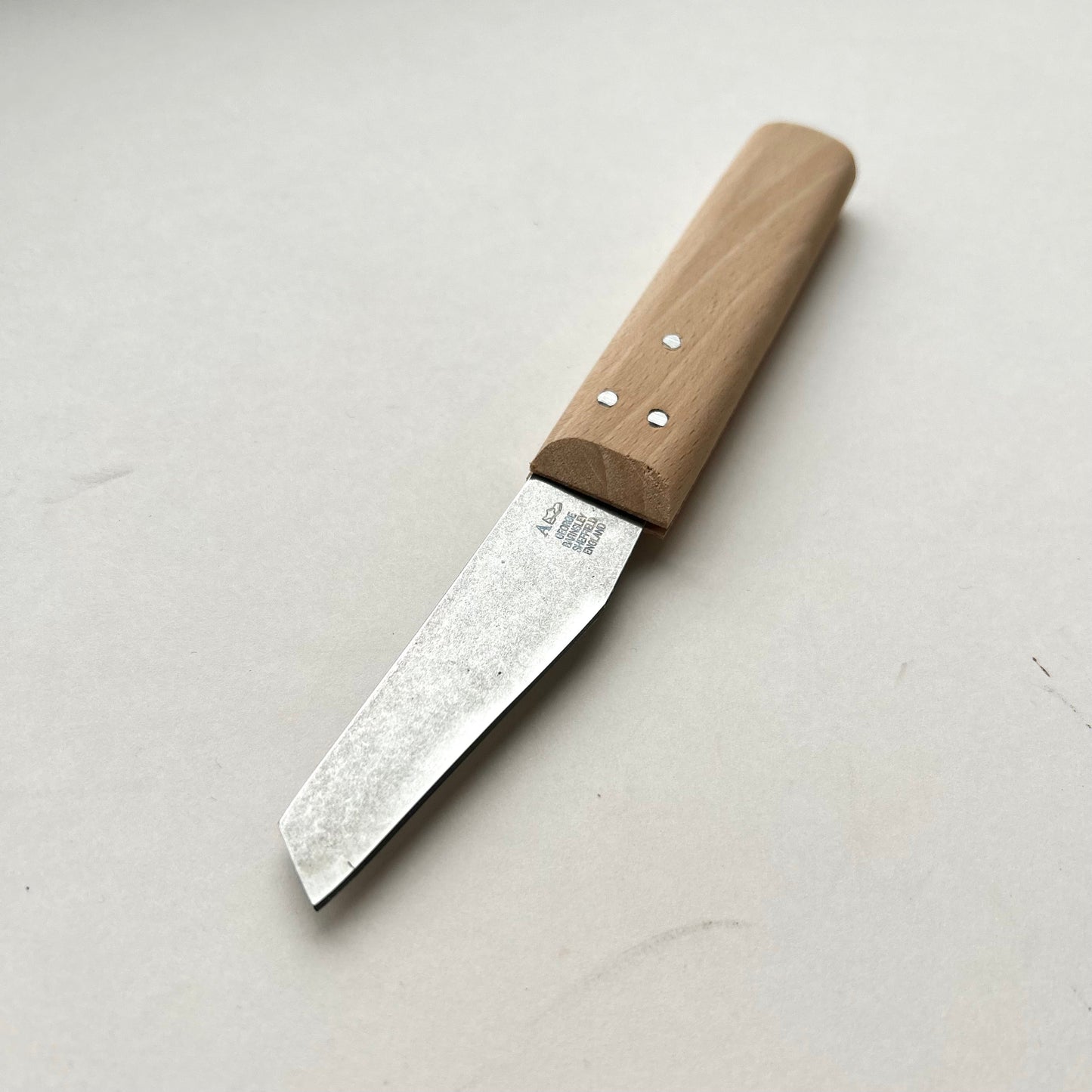 Knife with a wooden handle on a light gray background