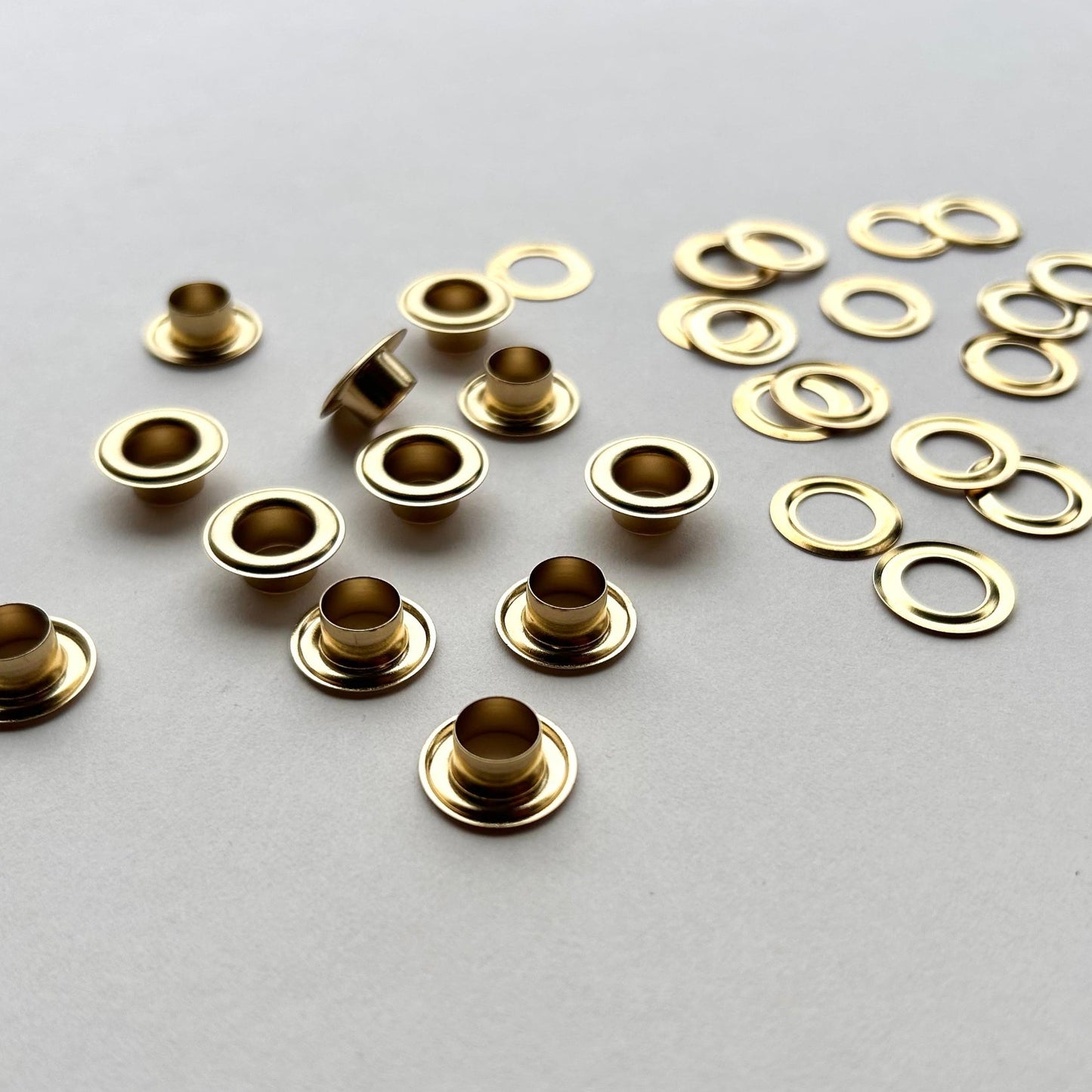 Gold metal eyelets on a gray background