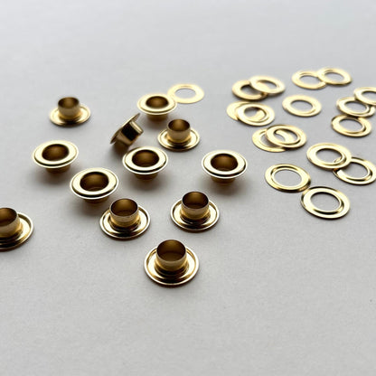 Gold metal eyelets on a gray background