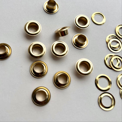 Gold eyelets on a light gray background