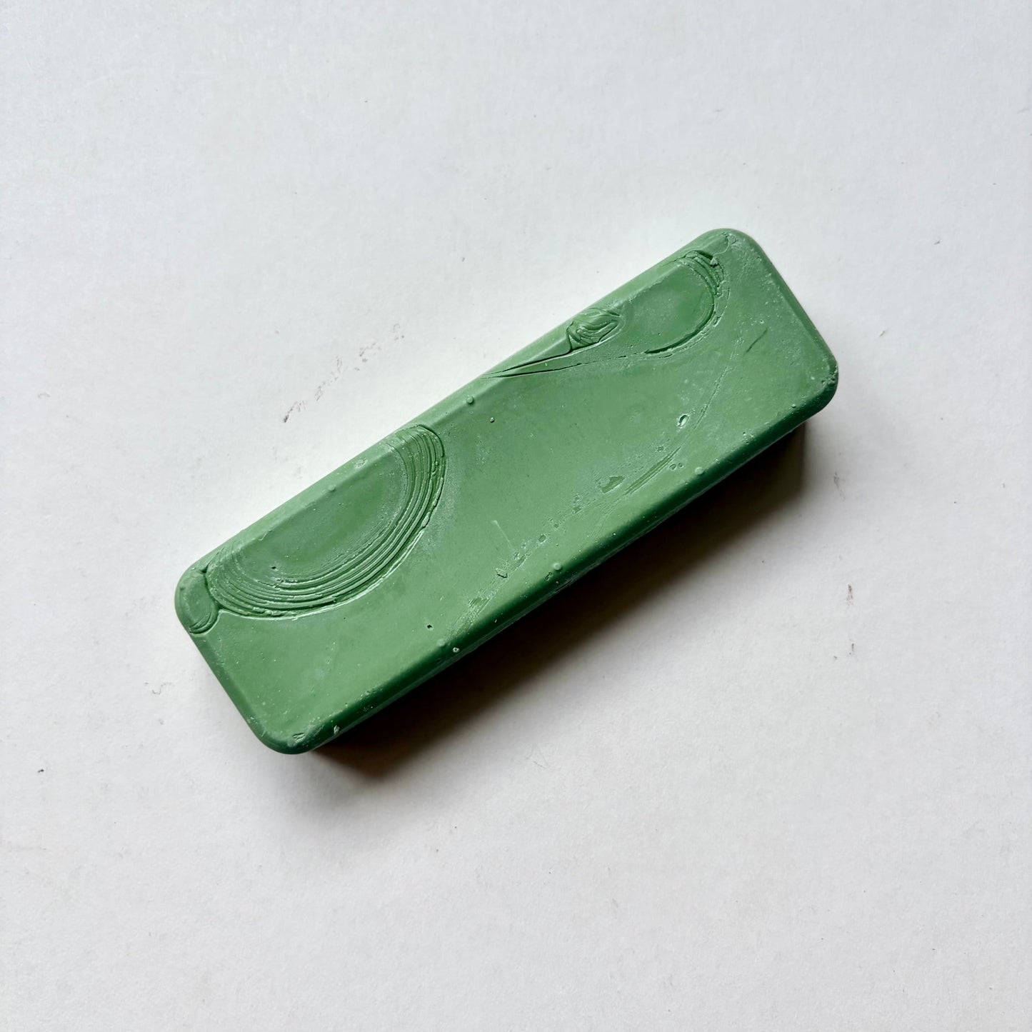 Green metal polishing bar on grey background