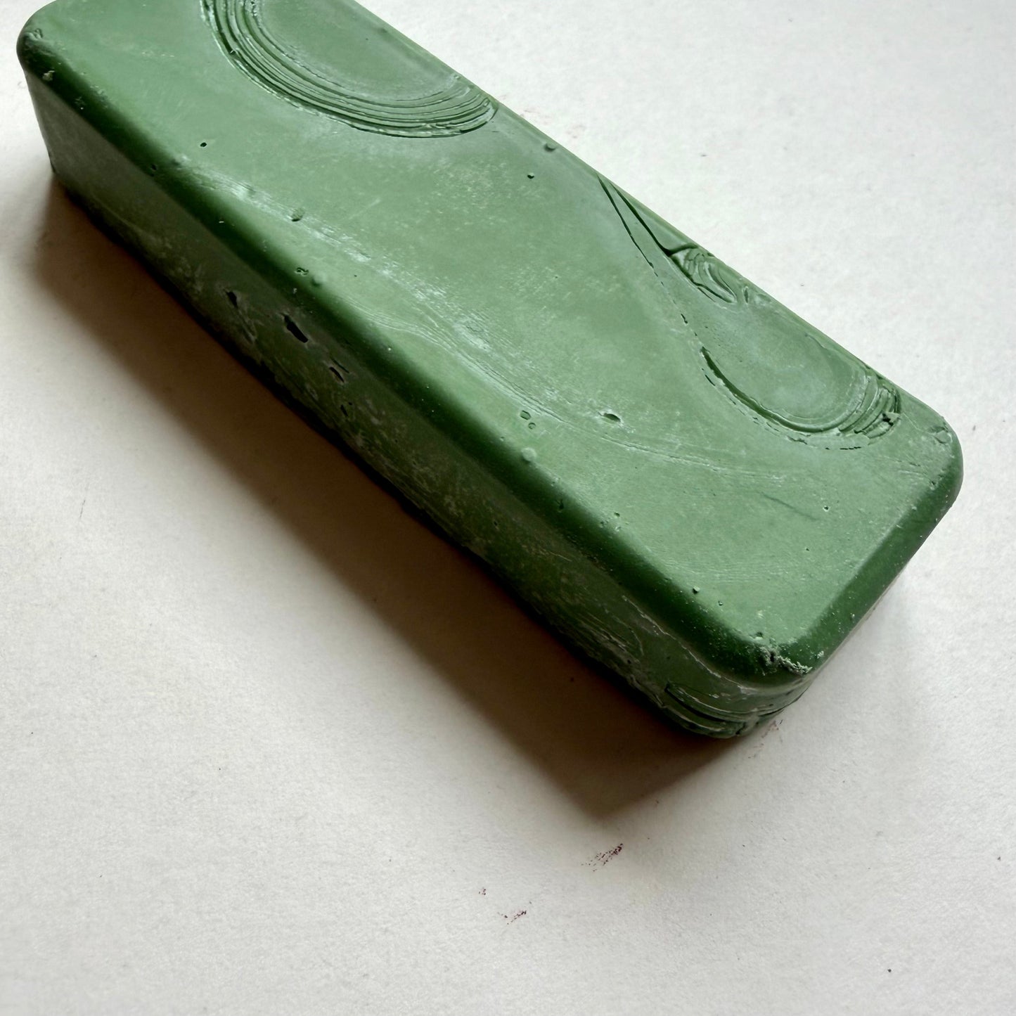 Green metal polishing bar on grey background