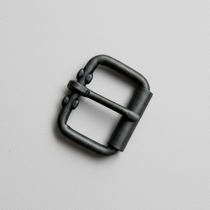 Black metal buckle on a light gray background