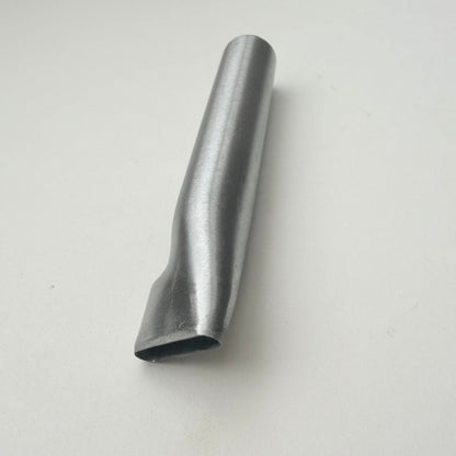 A metallic oblong punch for leather on a white background