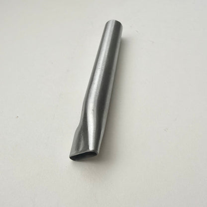 A metallic oblong punch for leather on a white background