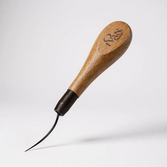 Wooden tool with a black pointed end on a white background
