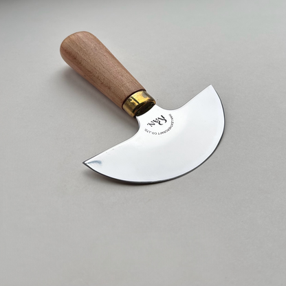Round head leather knife with wooden handle on a grey background