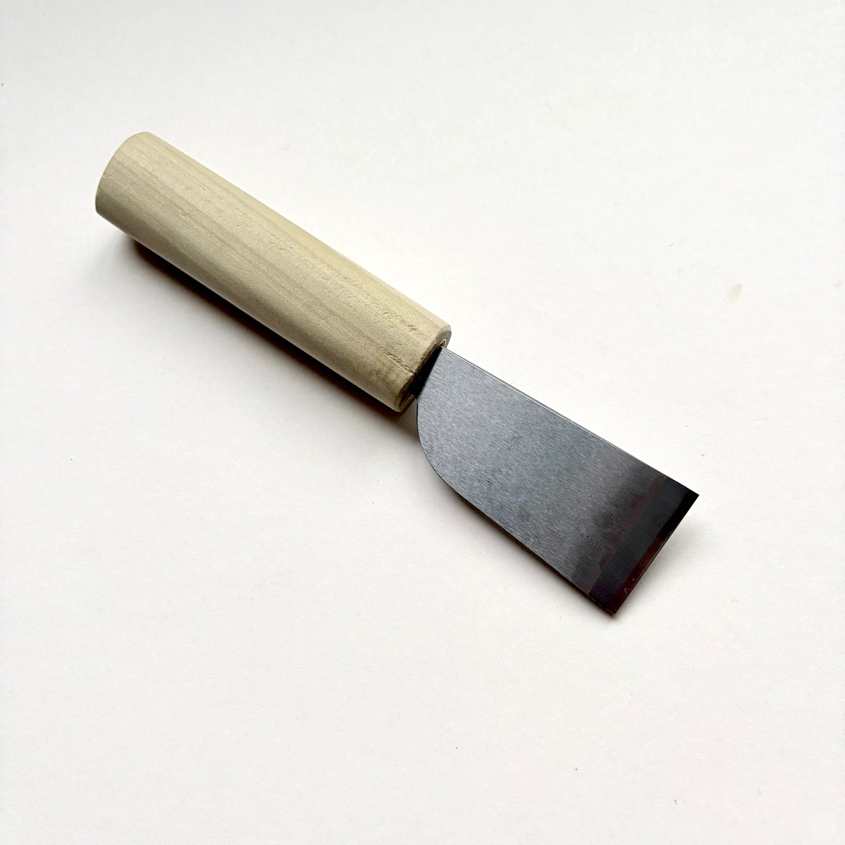 A Japanese-style wooden knife for leather with a light natural wood handle and a silver steel blade, photographed on a plain off-white background.