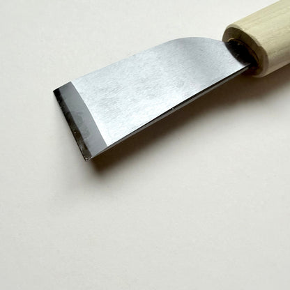 A Japanese-style wooden knife for leather with a light natural wood handle and a silver steel blade, photographed on a plain off-white background.