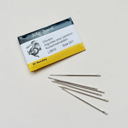 A pack of John James Glover sewing needles, size 001, with five individual silver metal needles displayed on a light off-white background.