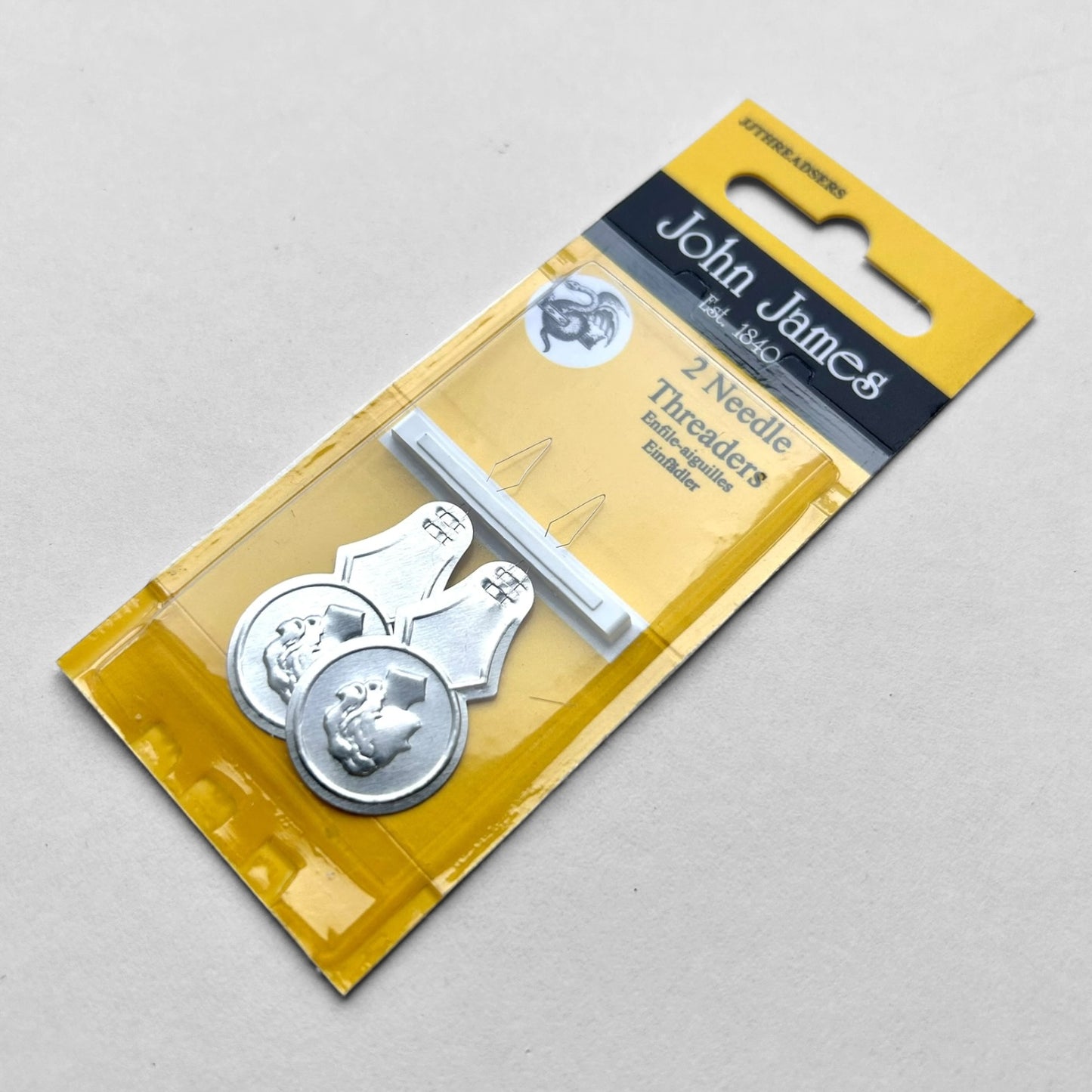 John James needle threader set in packaging on a gray background