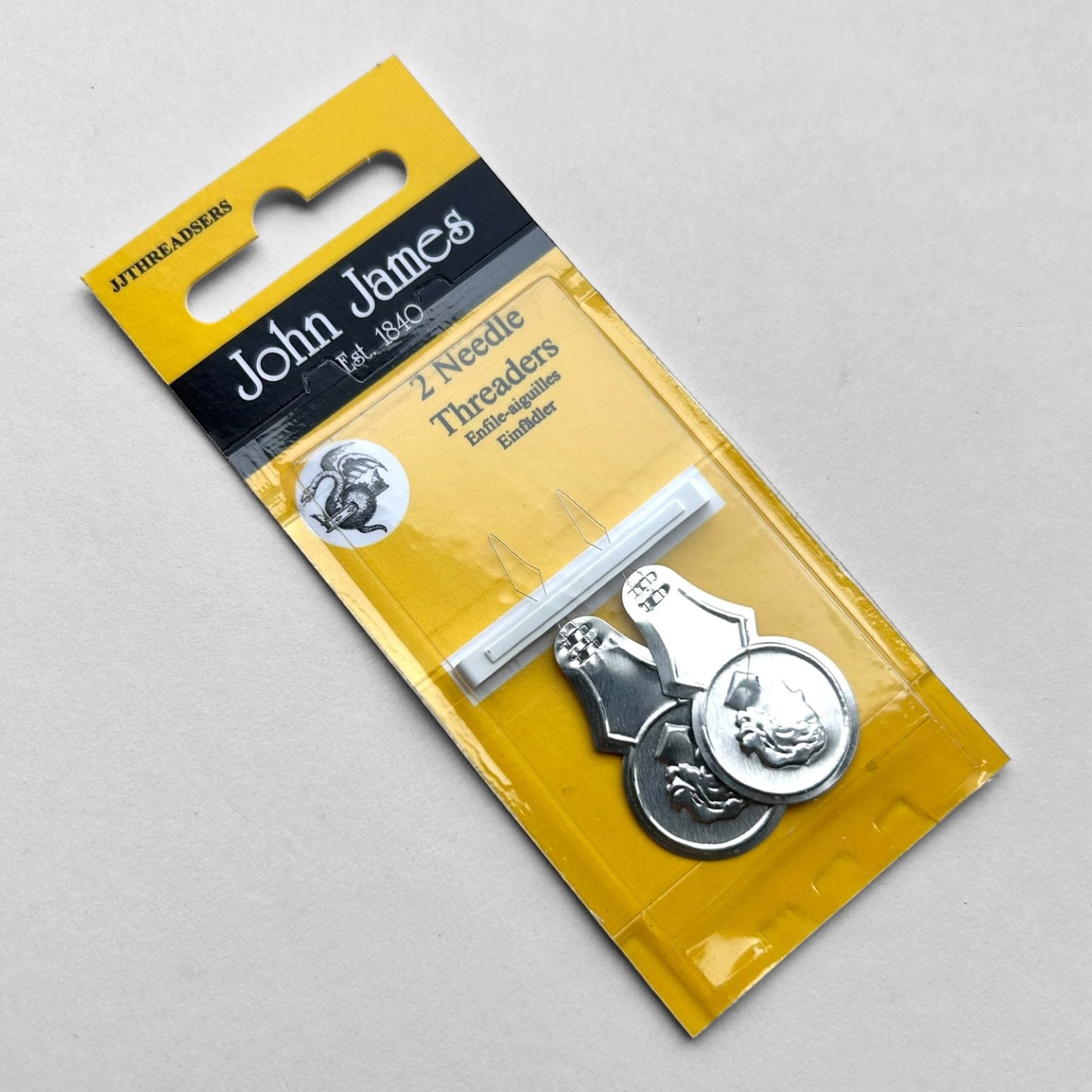 John James needle threaders in packaging on a gray background