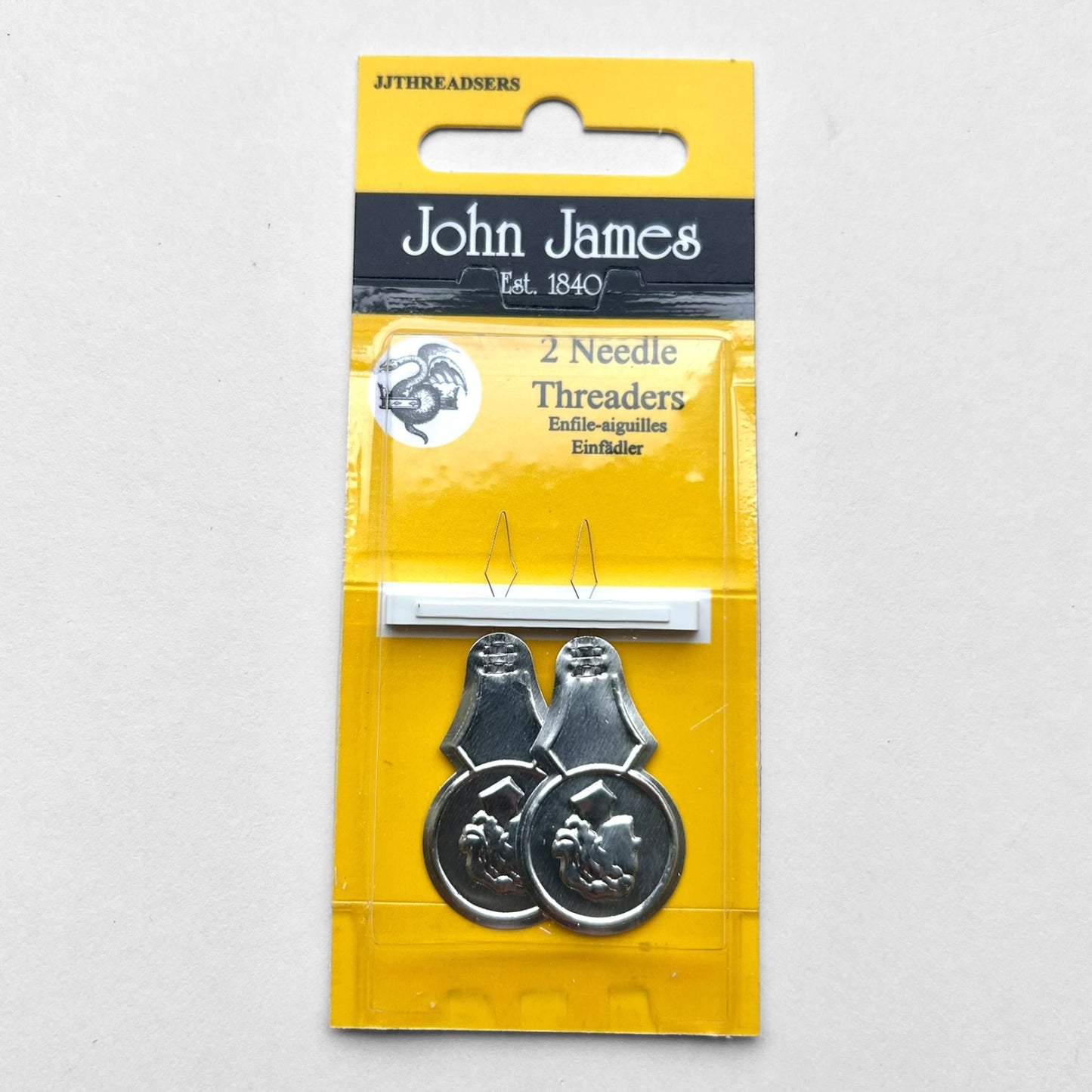 John James needle threaders in yellow packaging on a white background