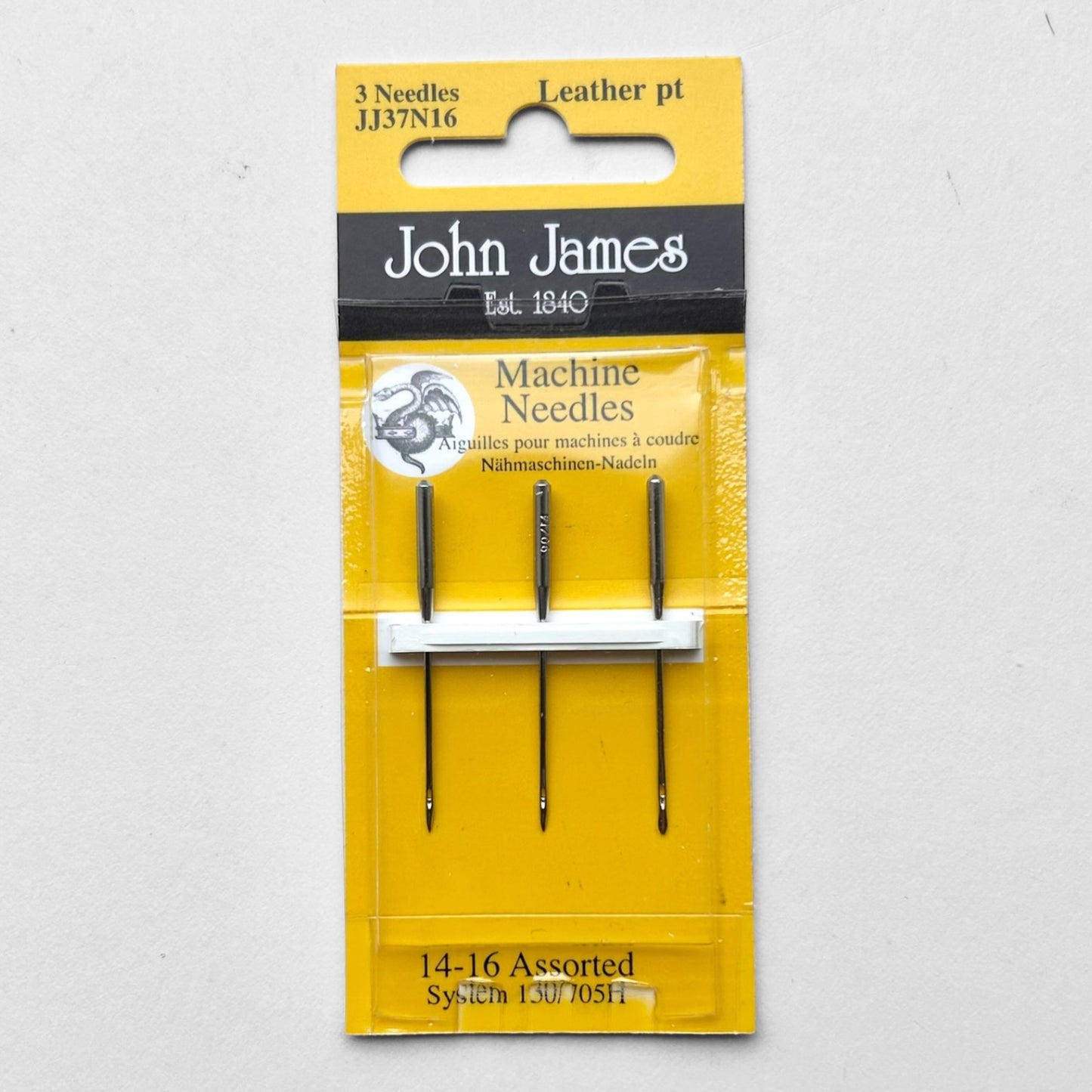 Packaged John James sewing machine needles on a grey background