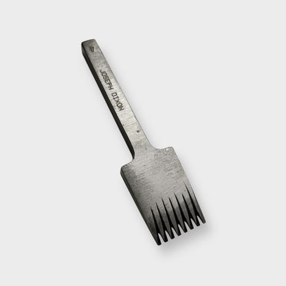 Metallic pricking iron leather tool with 'JOSEPH DIXON' engraving on a light gray background.