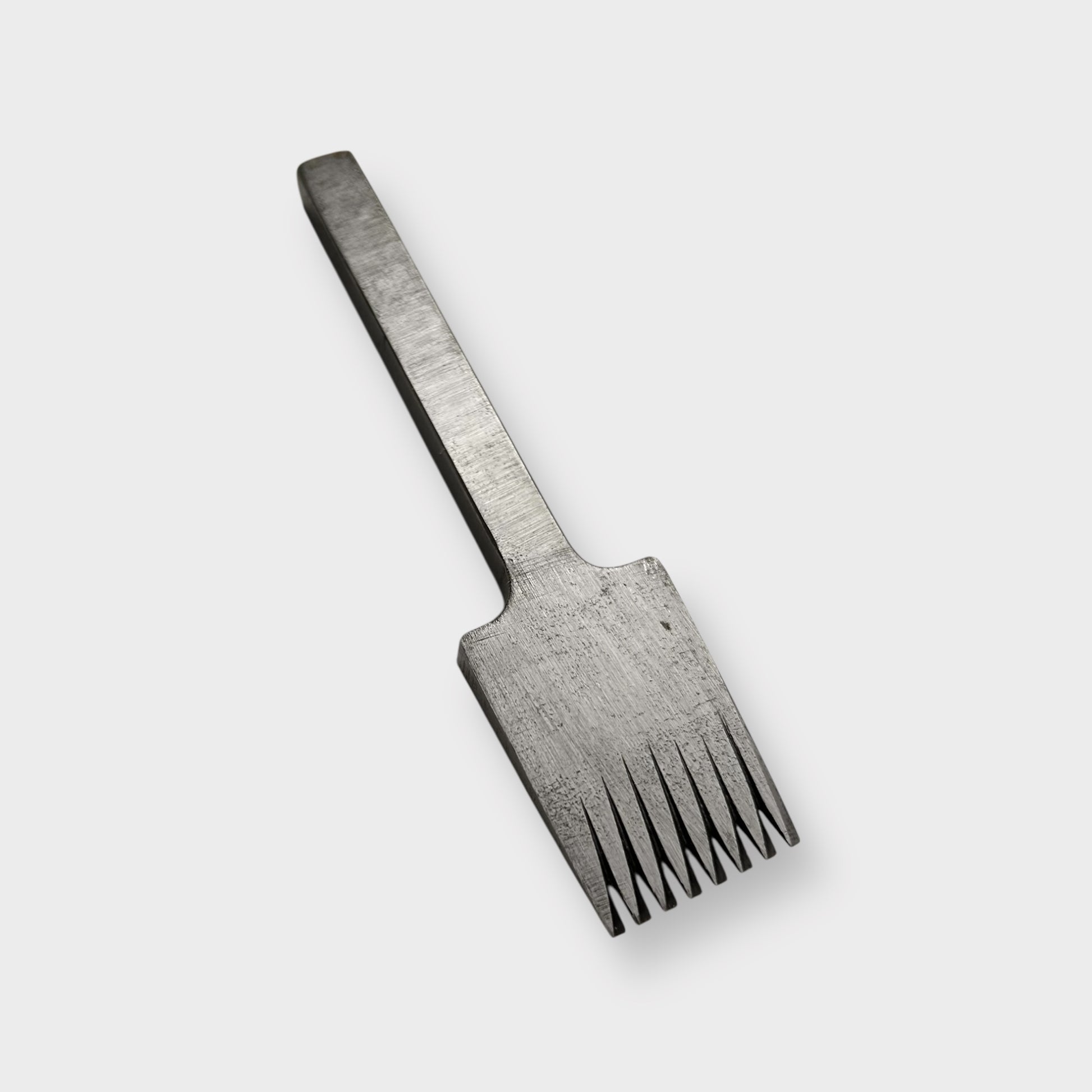 Metallic pricking iron leather tool with 'JOSEPH DIXON' engraving on a light gray background.