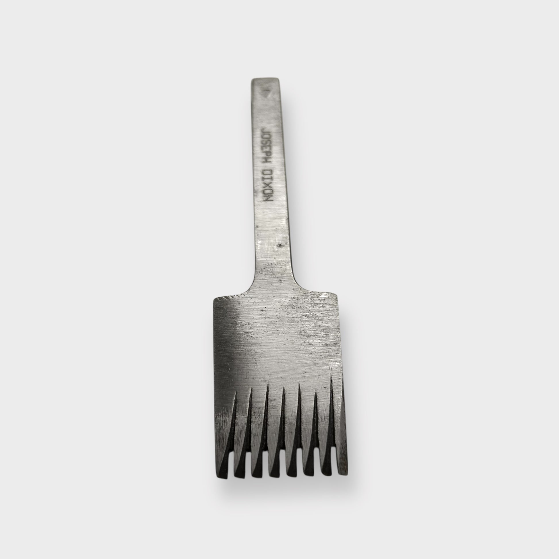 Metallic pricking iron leather tool with 'JOSEPH DIXON' engraving on a light gray background.