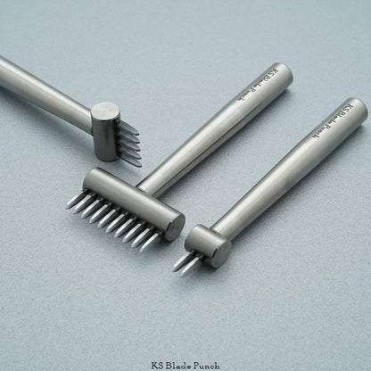 Set of metal blade punches on a light grey background