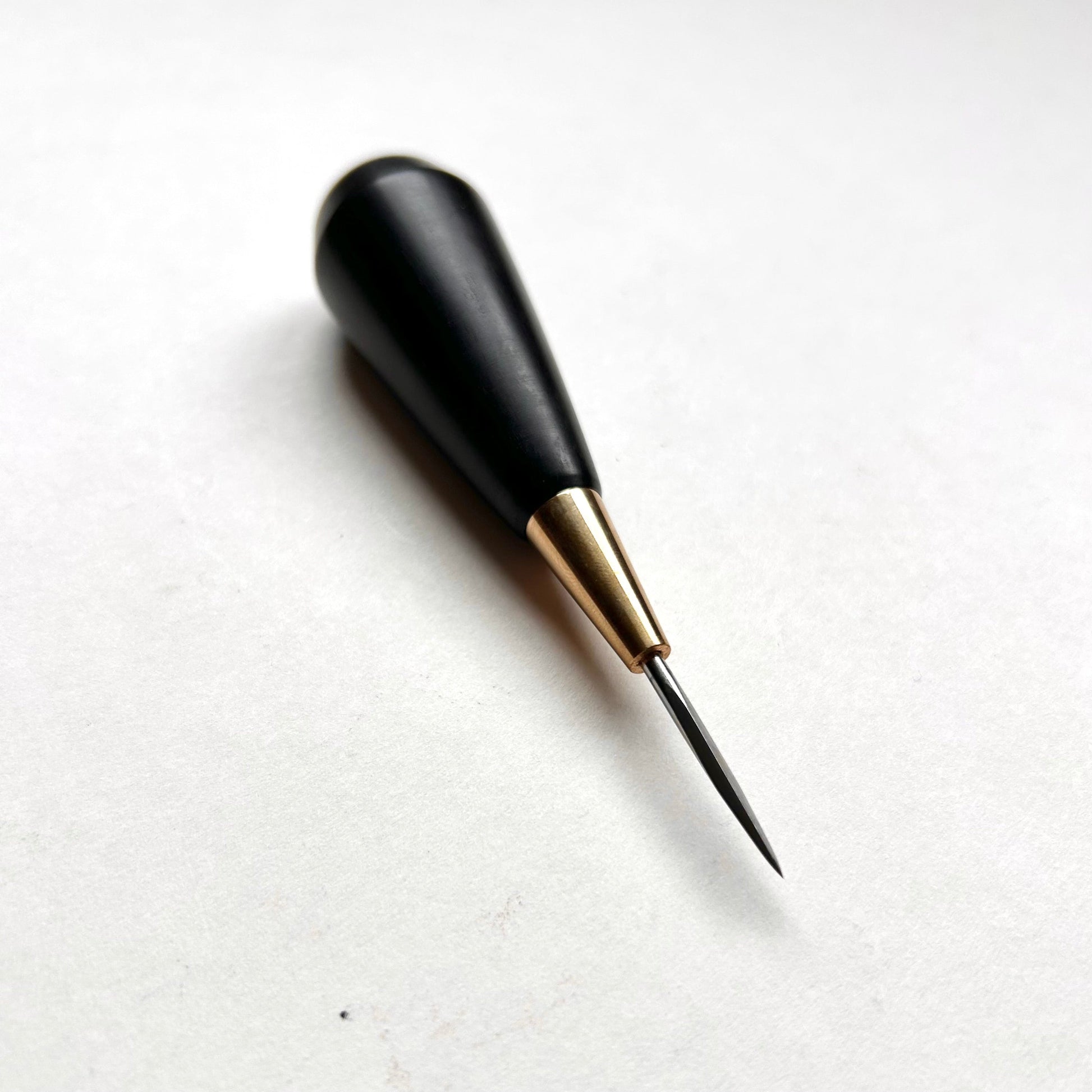 Black and gold leather diamond stitching awl by Kemovancraft on a white background