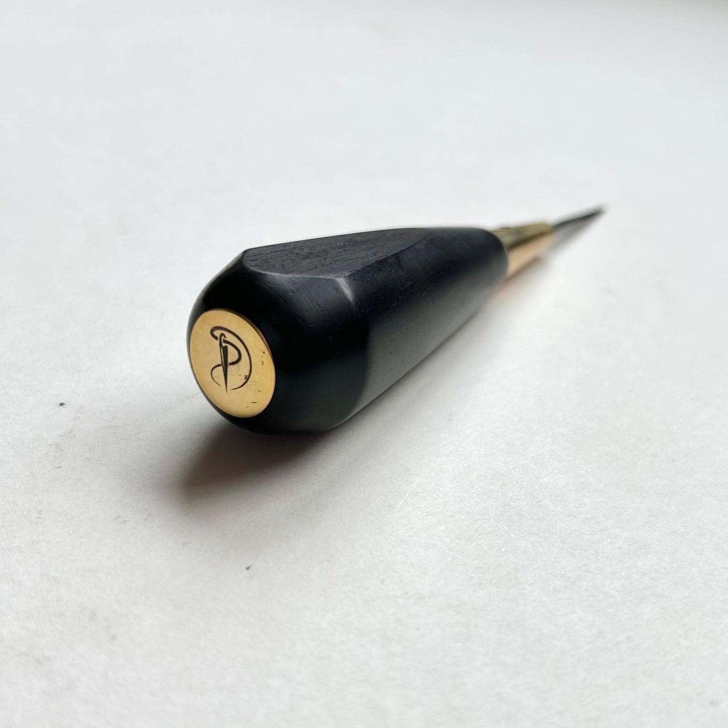 Black and gold leather diamond stitching awl by Kemovancraft on a white background