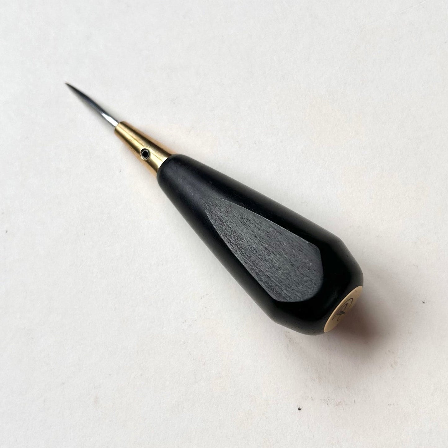 Black and gold leather diamond stitching awl by Kemovancraft on a white background