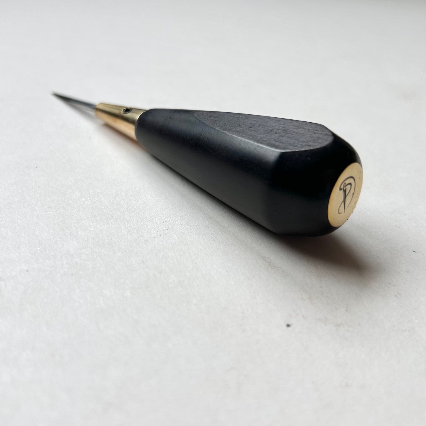 Black and gold leather diamond stitching awl by Kemovancraft on a white background