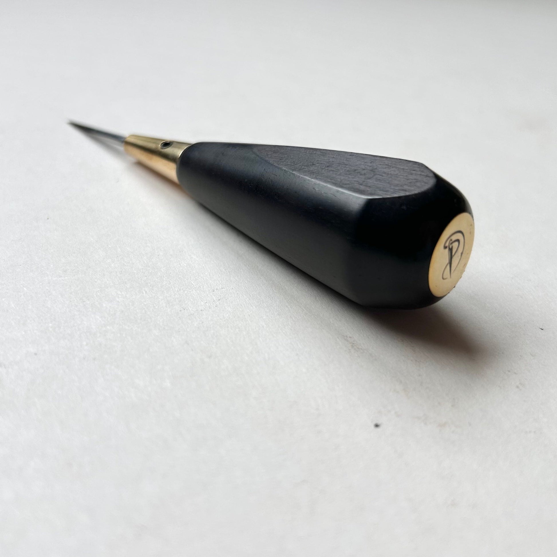 Black and gold leather diamond stitching awl by Kemovancraft on a white background