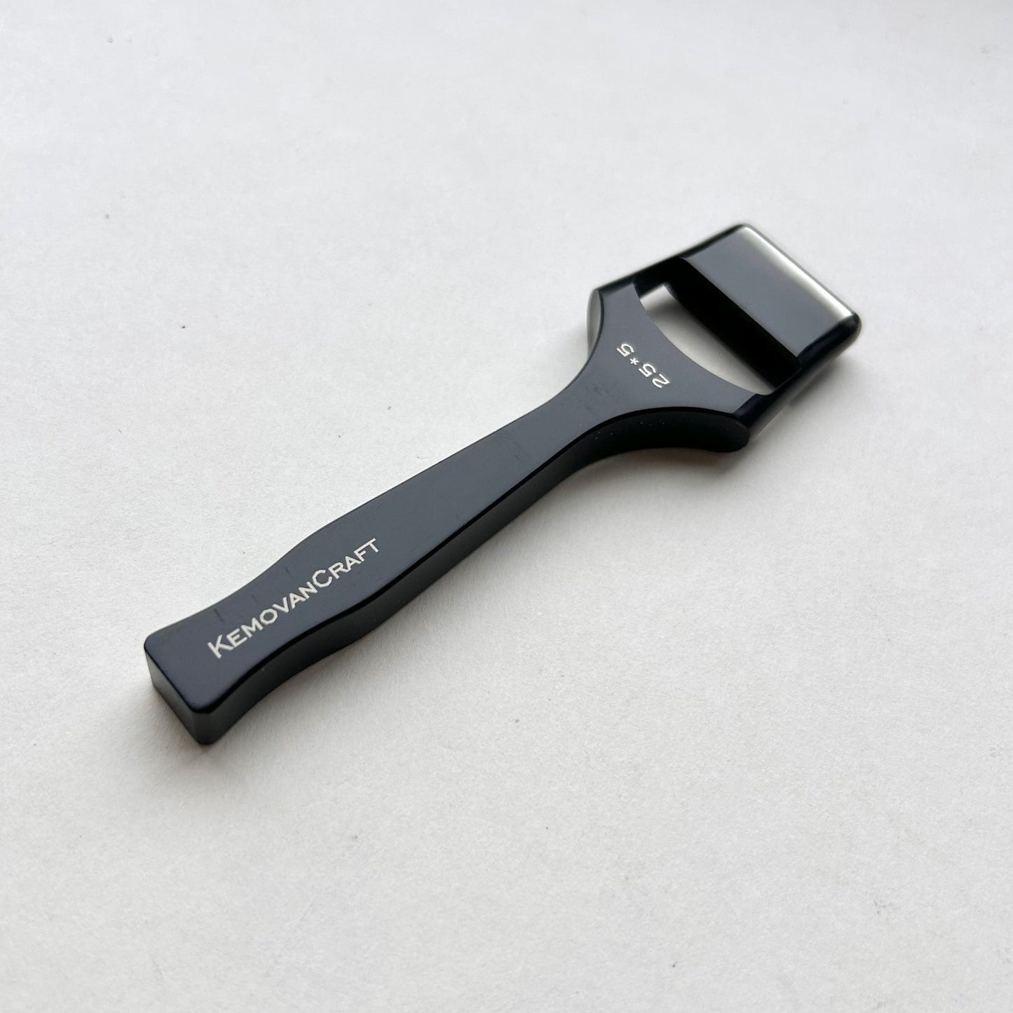 Black leather oblong slot punch tool with 'Kemovancraft' branding on a light gray background