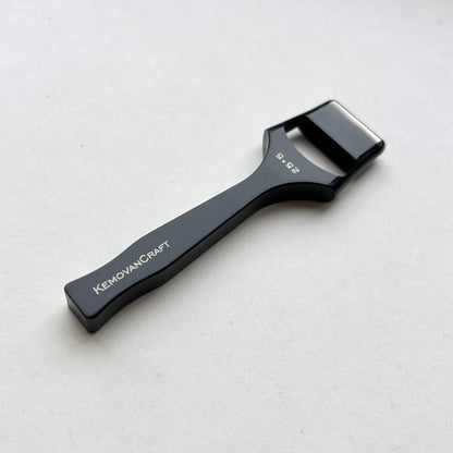 Black leather oblong slot punch tool with 'Kemovancraft' branding on a light gray background