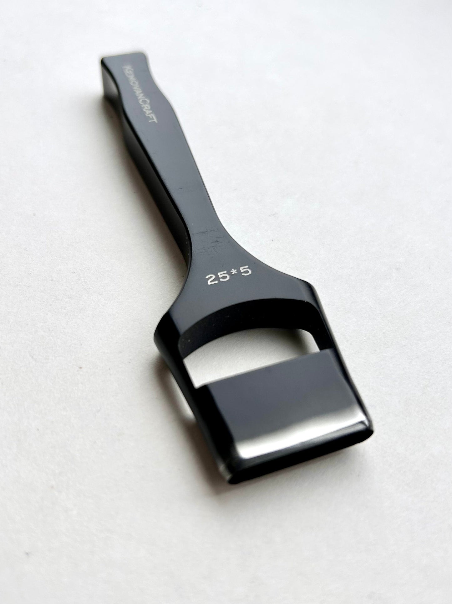 Black leather oblong slot punch tool with 'Kemovancraft' branding on a light gray background