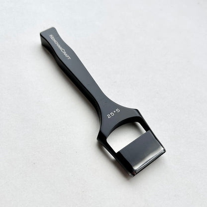 Black leather oblong slot punch tool with 'Kemovancraft' branding on a light gray background