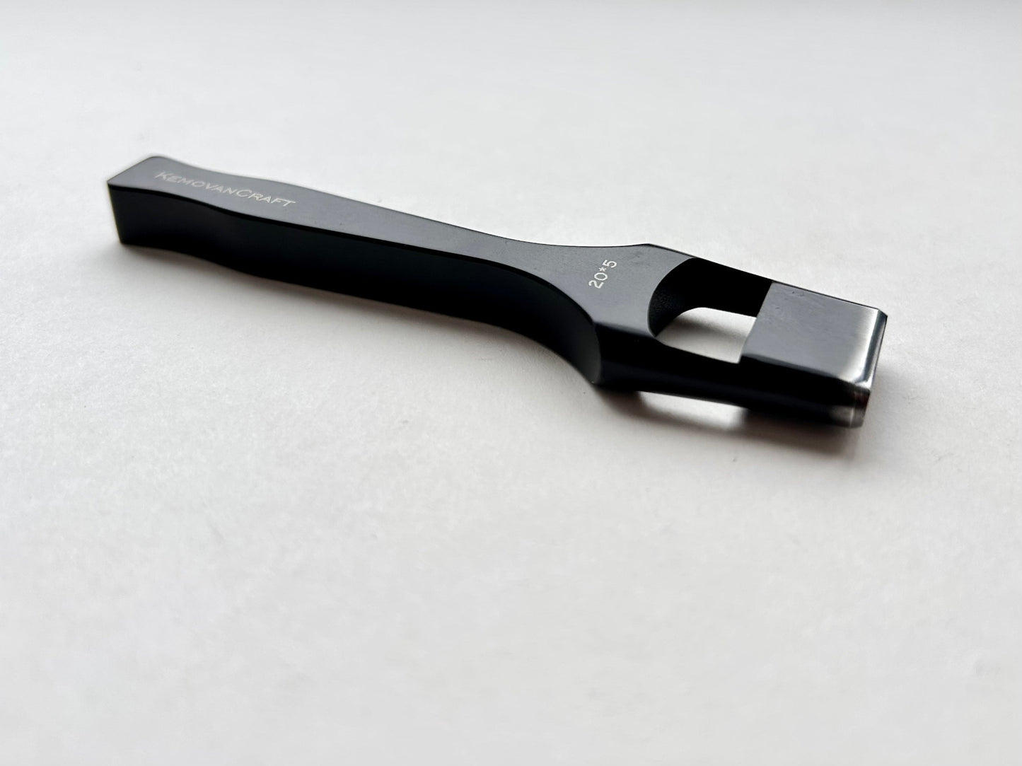 Black leather oblong slot punch tool with 'Kemovancraft' branding on a light gray background