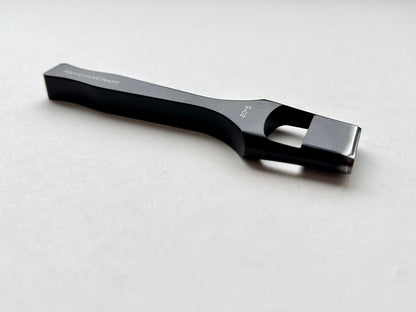Black leather oblong slot punch tool with 'Kemovancraft' branding on a light gray background