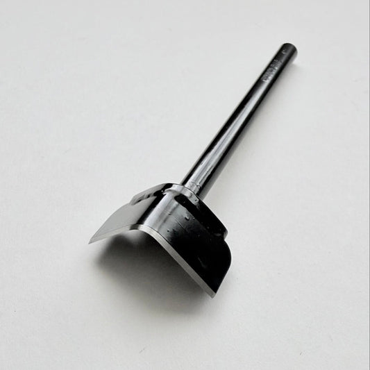 A black metal corner punch for leather with a long straight black handle, photographed on a plain light grey background.