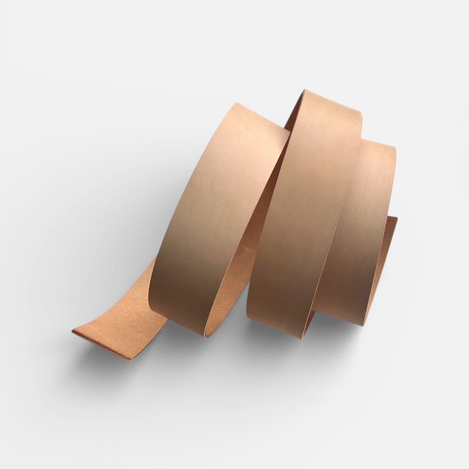 Natural leather belt blank on a light grey background