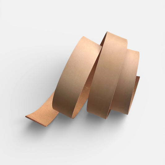 Natural leather belt blank on a light grey background