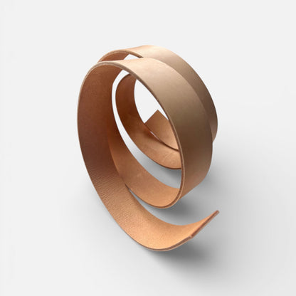 Natural leather belt blank on a light grey background