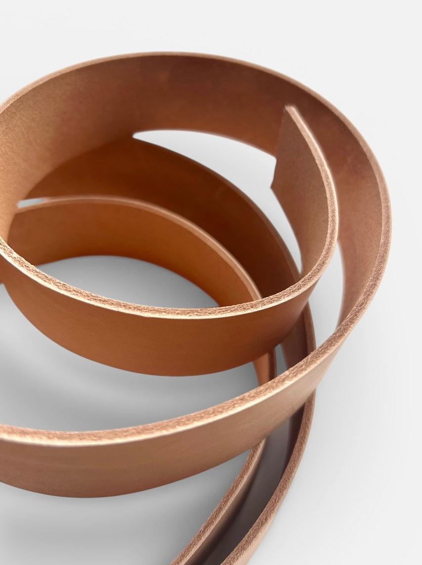 Natural leather belt blank on a light grey background