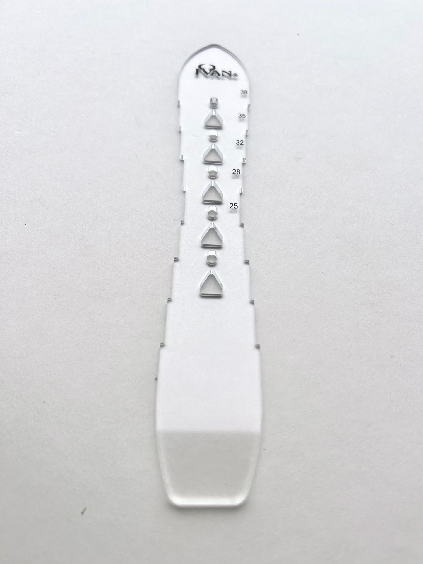 Leather belt hole template on a grey background
