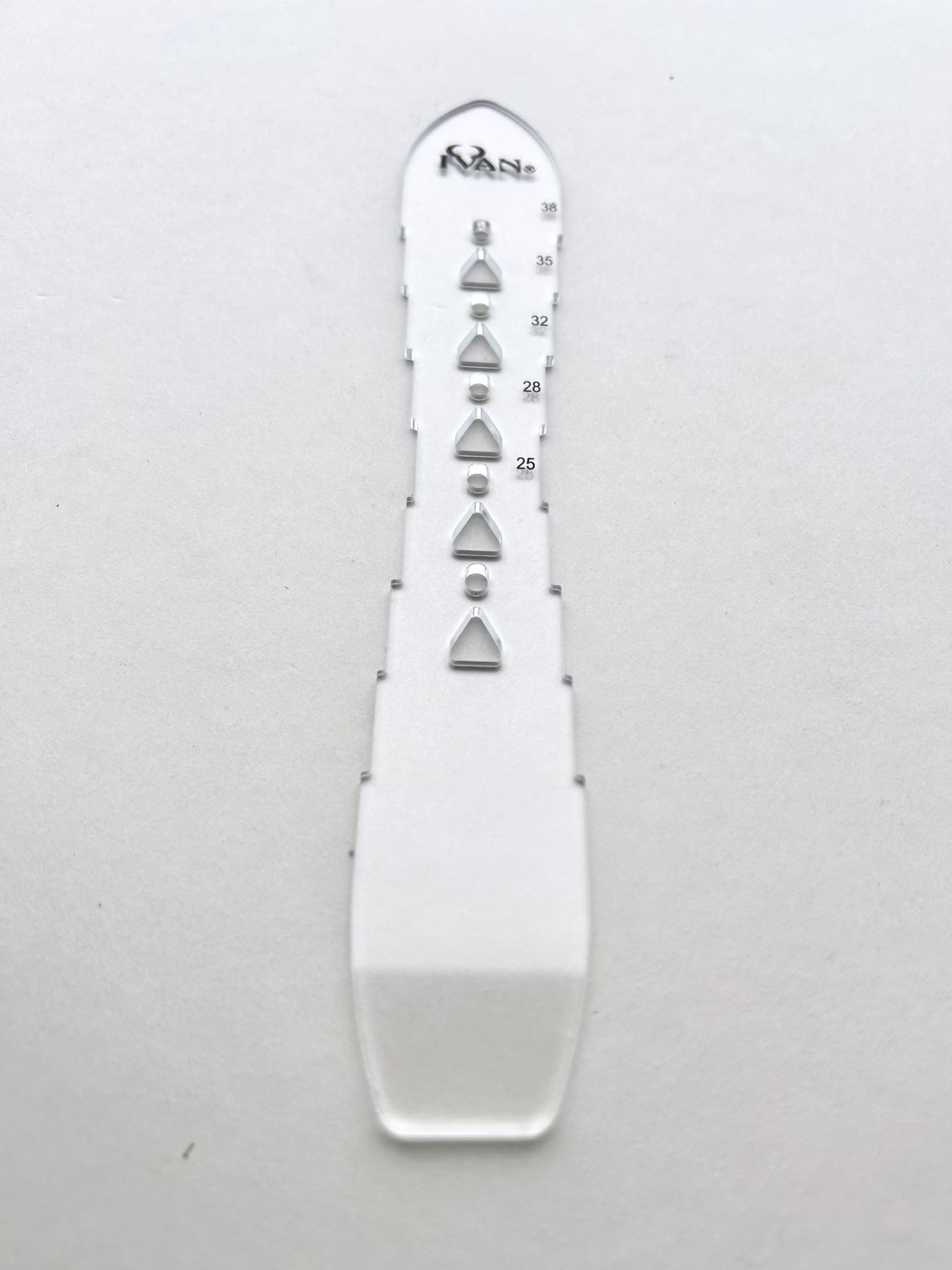 Leather belt hole template on a grey background